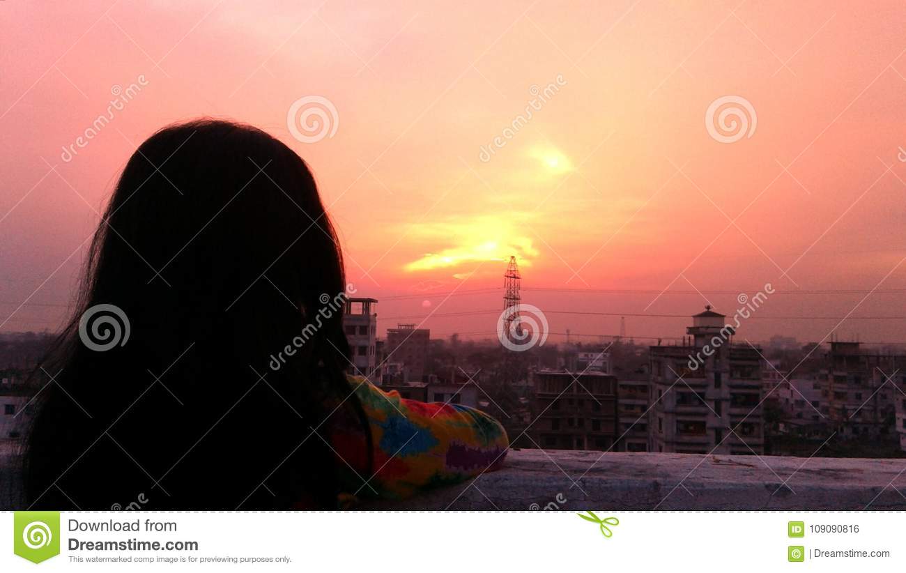 girl watching sunset from rooftop
